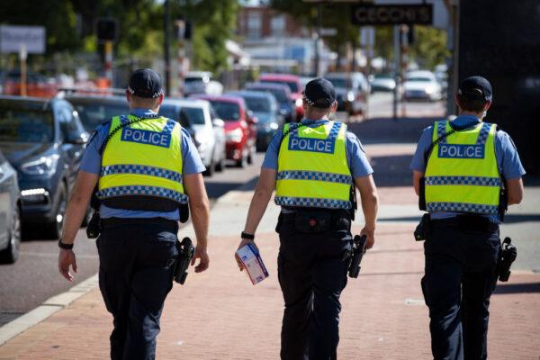 Police are seen on patrol at a COVID-19 drive-through clinic in Inglewood, where members of the public have waited over two hours in line in Perth, Australia, on Feb. 1, 2021. (Matt Jelonek/Getty Images)