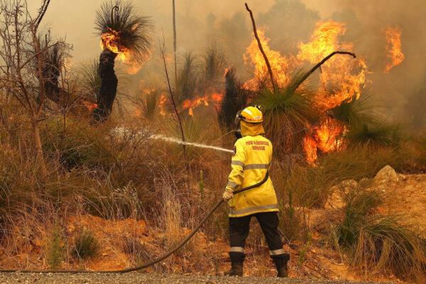 Fire crews control bush fires as they approach properties on Copley Road in Upper Swan on February 02, 2021, in Perth, Australia. (Paul Kane/Getty Images)