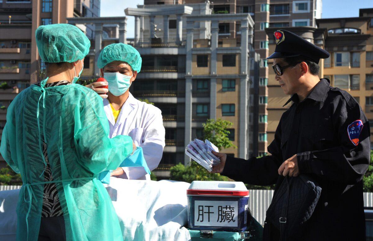  Adherents of the spiritual practice Falun Gong act out a scene of organ harvesting, during a demonstration in Taipei on July 20, 2014, against China's persecution of the group. (Mandy Cheng/AFP via Getty Images)