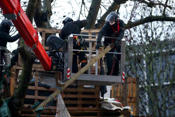 Bailiffs dismantle a structure at a "Stop HS2" camp at Euston Station in London on Jan. 30, 2021. (Hollie Adams/Getty Images)