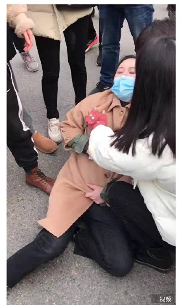Screenshot of an online video showing a pregnant woman on the site of protest collapses after being beaten by police.