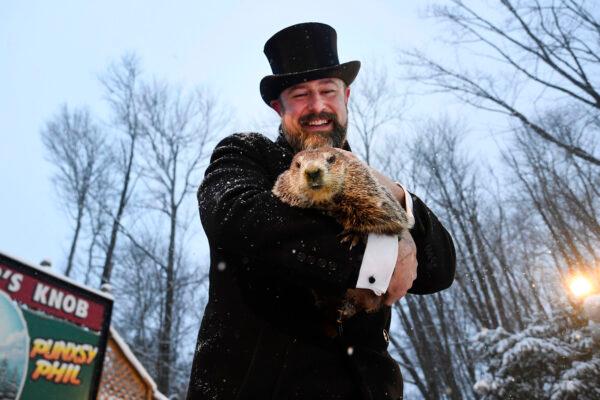 Groundhog Club handler A.J. Dereume holds Punxsutawney Phil, the weather prognosticating groundhog, during the 135th celebration of Groundhog Day on Gobbler's Knob in Punxsutawney, Pa., on Feb. 2, 2021. (Barry Reeger/AP Photo)