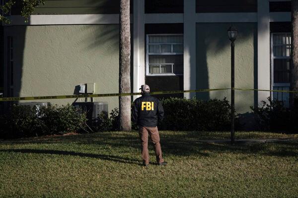 Law enforcement personnel continue to work at an apartment complex the day after a deadly shooting in Sunrise, Fla., on Feb. 3, 2021. Several FBI agents were killed and others were wounded while trying to serve a search warrant on a child pornography suspect in Florida.<br/>(Joe Cavaretta/South Florida Sun-Sentinel via AP)