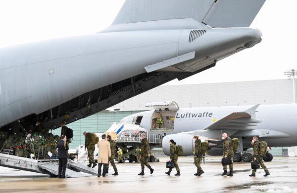 Staff members enter aboard an A400M military transport plane to COVID-19 stricken Portugal in Wunstorf, Germany, on Feb. 3, 2021. (Fabian Bimmer/Reuters)