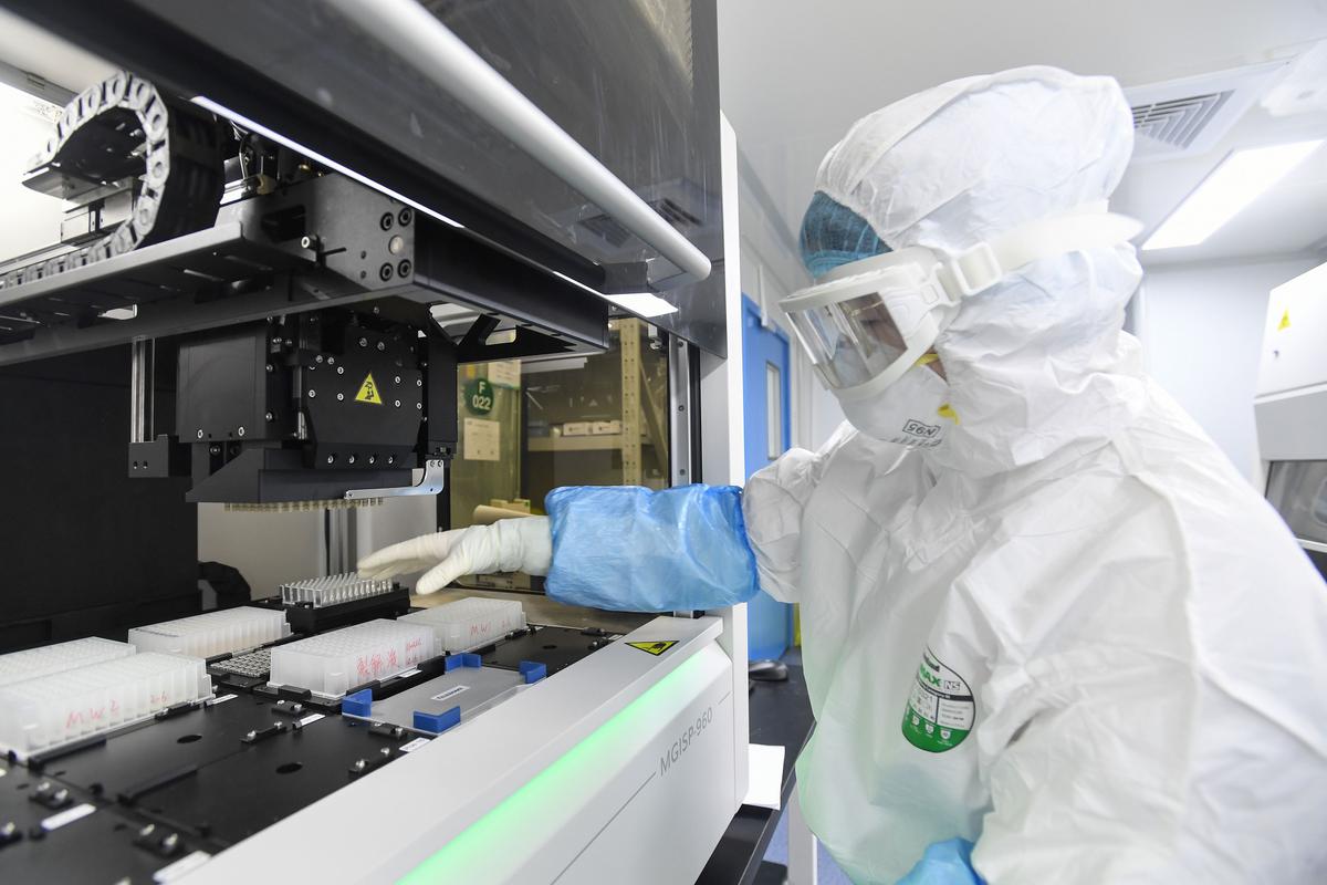 A laboratory technician working on samples from people to be tested for COVID-19 at "Fire Eye" laboratory in Wuhan in China's central Hubei Province on Feb. 6, 2020. BGI Group, a genome sequencing company based in southern China, said it opened a lab in Wuhan able to test up to 10,000 people per day for COVID on Feb. 5, 2020. (STR/AFP via Getty Images)