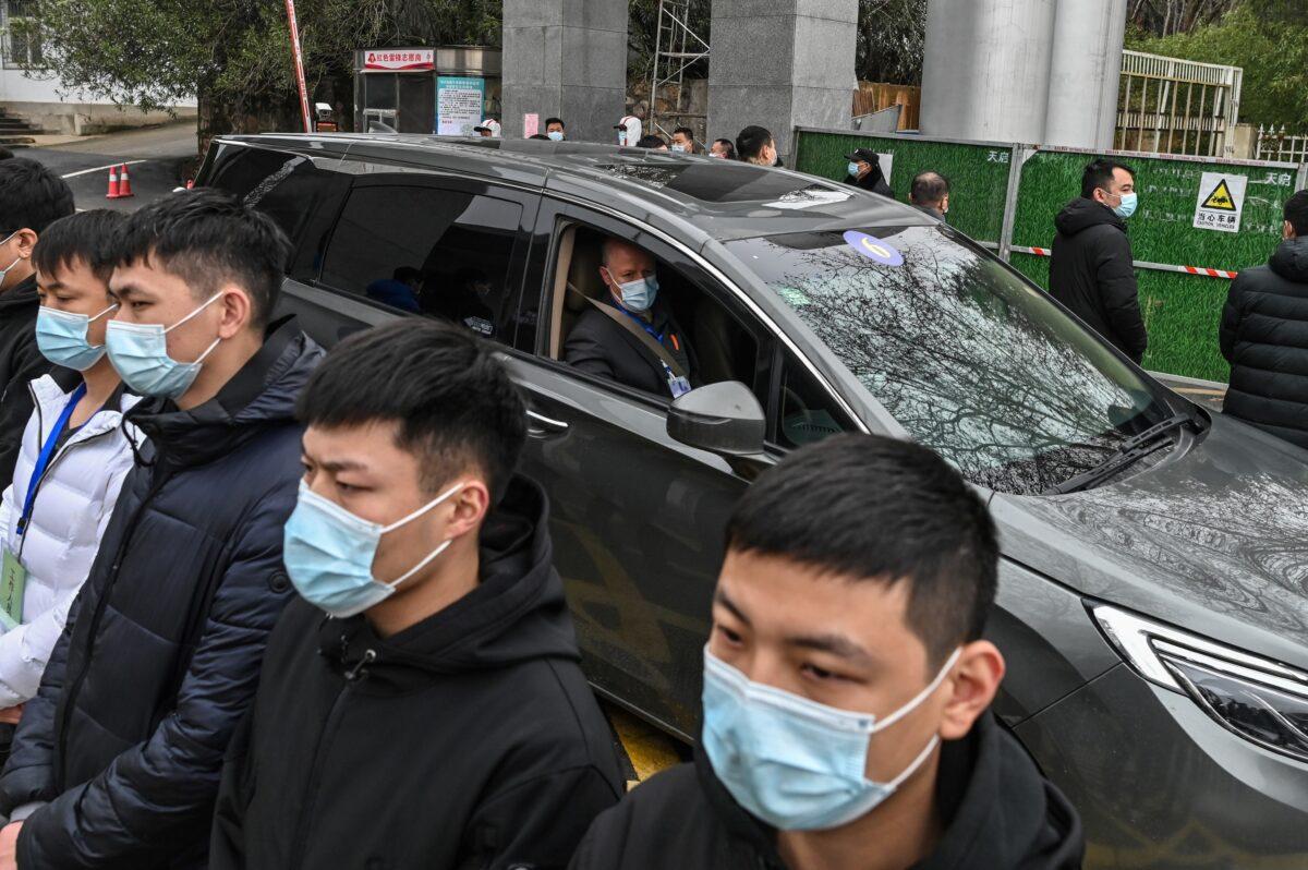 Members of the World Health Organization (WHO) team investigating the origins of COVID-19 leave the Hubei provincial center for disease control and prevention, in Wuhan, China, on Feb. 1, 2021. (Hector Retamal/AFP via Getty Images)