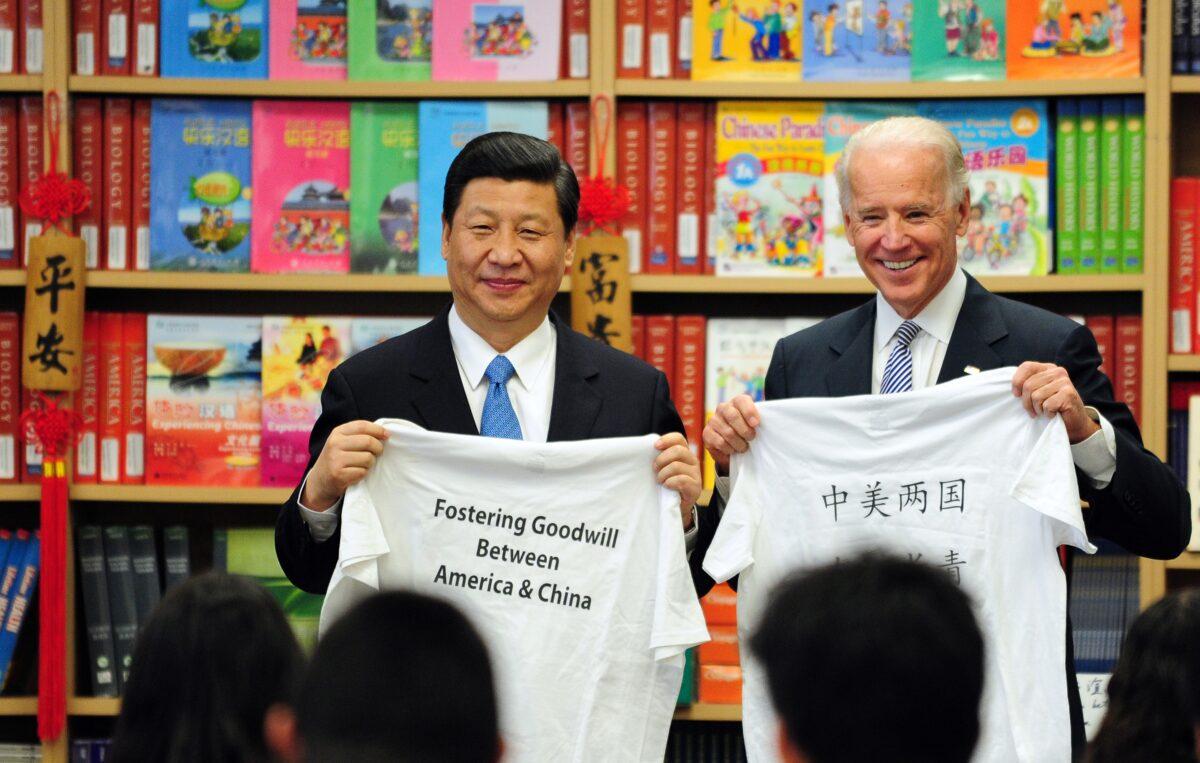 Then-U.S. Vice President Joe Biden and then-Chinese vice chair Xi Jinping display shirts with a message given to them by students at the International Studies Learning School in Southgate, outside of Los Angeles, Calif., on Feb. 17, 2012. (Frederic J. Brown/AFP via Getty Images)