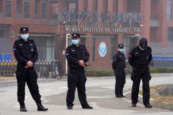 Security personnel gather near the entrance of the Wuhan Institute of Virology during a visit by the World Health Organization team in Wuhan in China's Hubei Province, China, on Feb. 3, 2021. (Ng Han Guan/AP Photo)