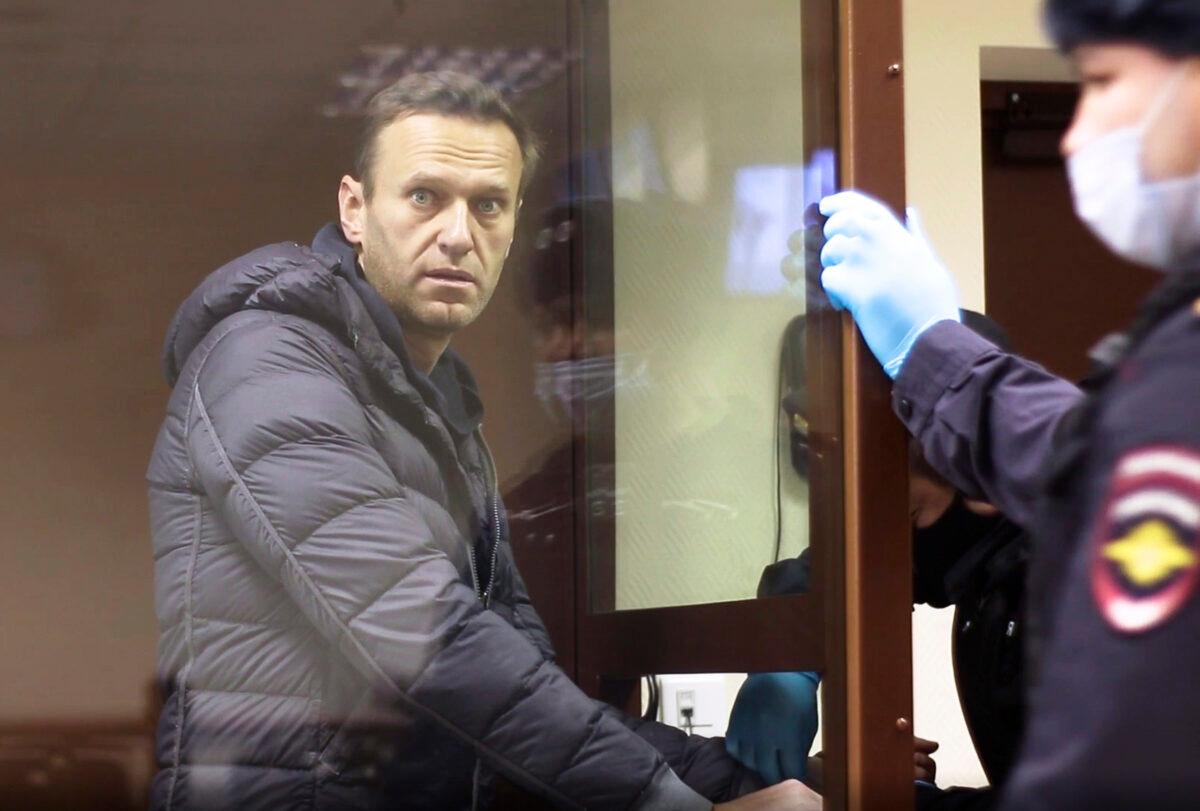 Russian opposition leader Alexei Navalny stands in a cage during a hearing on his charges for defamation, in the Babuskinsky District Court in Moscow, Russia on Feb. 5, 2021.(Babuskinsky District Court via AP)