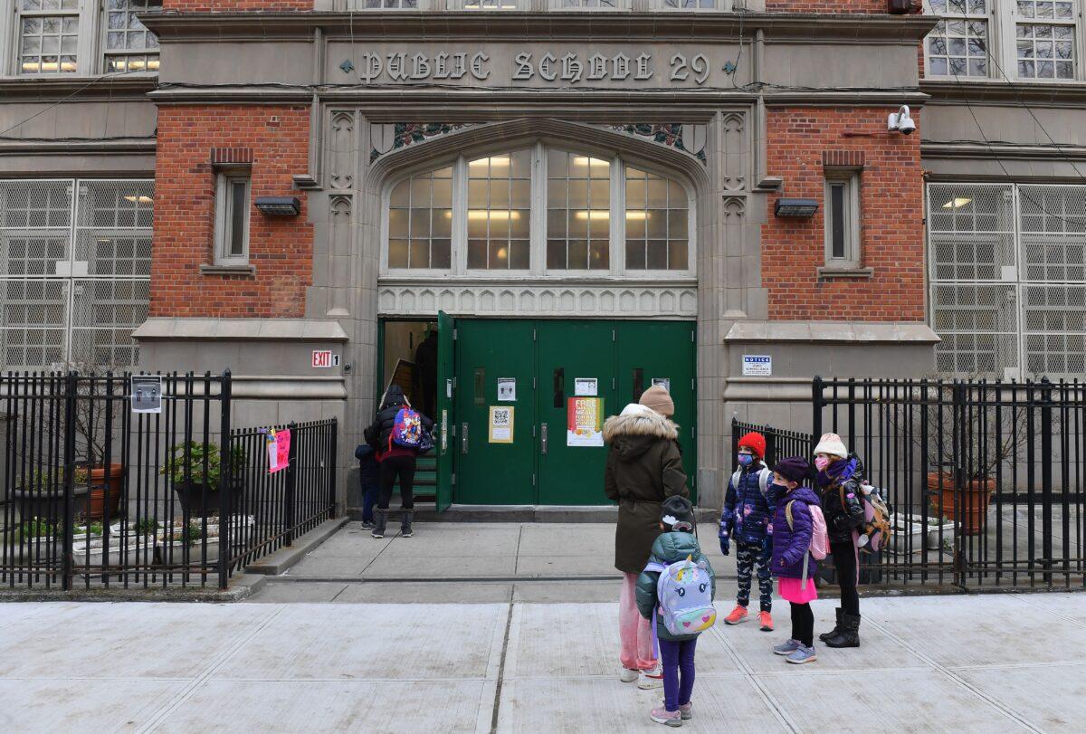 Children arrive for class on the first day of school reopening, in New York City on Dec. 7, 2020. (Angela Weiss/AFP via Getty Images)