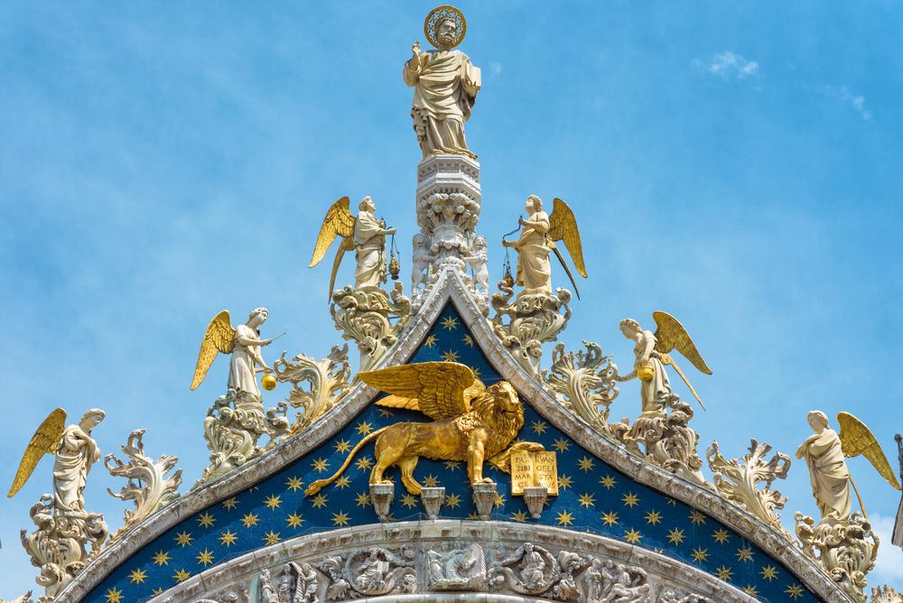 A statue of St. Mark, the patron of Venice, stands proudly on the basilica. The winged lion, below, is his symbol and also the symbol of Venice. (Viacheslav Lopatin/Shutterstock.com)