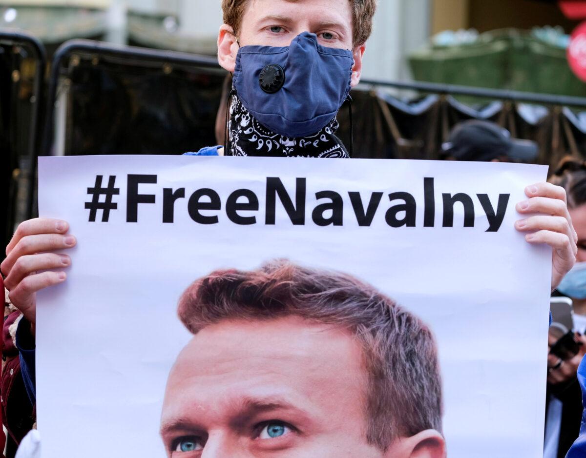 A protester holds a poster of Alexei Navalny in Hollywood during a demonstration in support of Russian opposition leader Alexei Navalny, in Los Angeles on Feb. 6, 2021. (Ringo Chiu/Reuters)