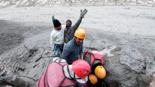 A man reacts after he was pulled out from beneath the ground by Indo Tibetan Border Police personnel during rescue operations in Tapovan area of the northern state of Uttarakhand, India, on Feb. 7, 2021. (Indo Tibetan Border Police via AP)