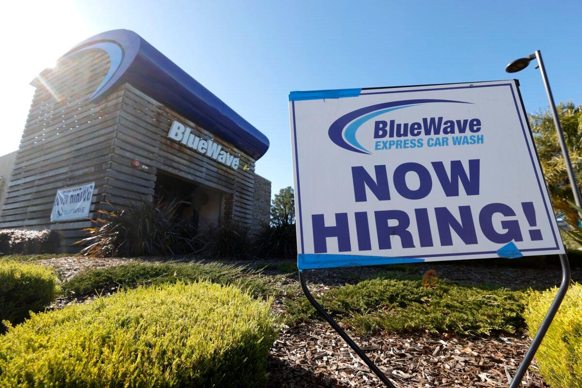 A sign advertising for workers is posted in front of the Blue Wave car wash in San Rafael, Calif., on Feb. 5, 2021. (Justin Sullivan/Getty Images)