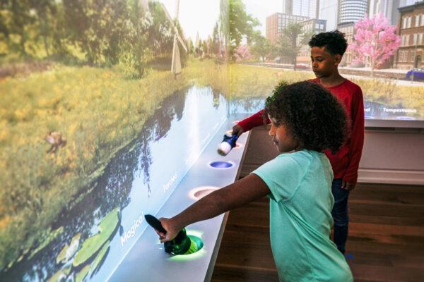 Visitors to the Planet Word Museum in Washington experiment in the Painting With Adjectives exhibit. (Courtesy of DuHon Photography)