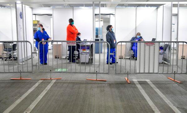 Medical personnel people await to administer Covid-19 vaccines on the opening day of a large-scale Covid-19 vaccination site at a parking structure at Cal Poly Pomona University in Pomona, Calif., on Feb. 5, 2021. (Frederic J. Brown/AFP via Getty Images)