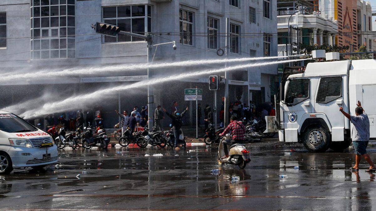Police use water cannons to disperse demonstrators during a protest in Mandalay, Burma, on Feb. 9, 2021. (AP Photo)