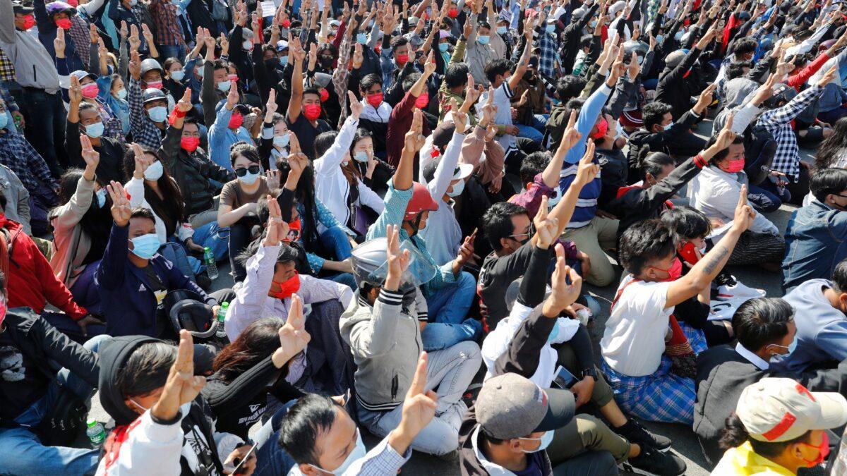 Protesters flash the three-fingered salute, a symbol of resistance, during a protest in Mandalay, Burma, on Feb. 9, 2021. (AP Photo)