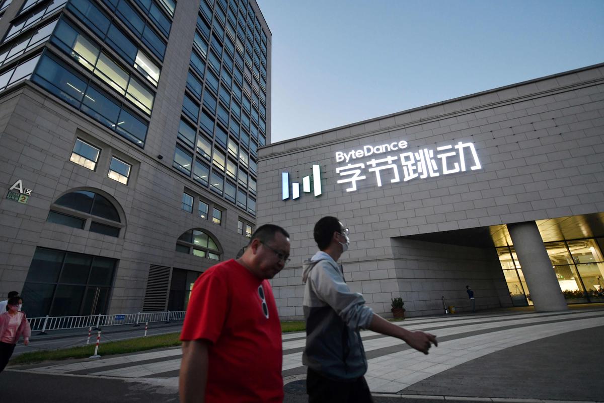  People walk past the headquarters of ByteDance, the parent company of video-sharing app TikTok, in Beijing on Sept. 16, 2020. (Greg Baker/AFP via Getty Images)