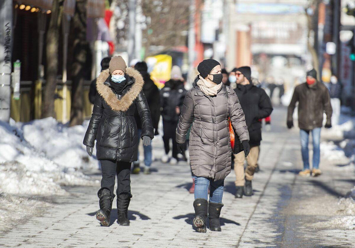 People walk along a street in Montreal, Canada, on Jan. 31, 2021. (The Canadian Press/Graham Hughes)