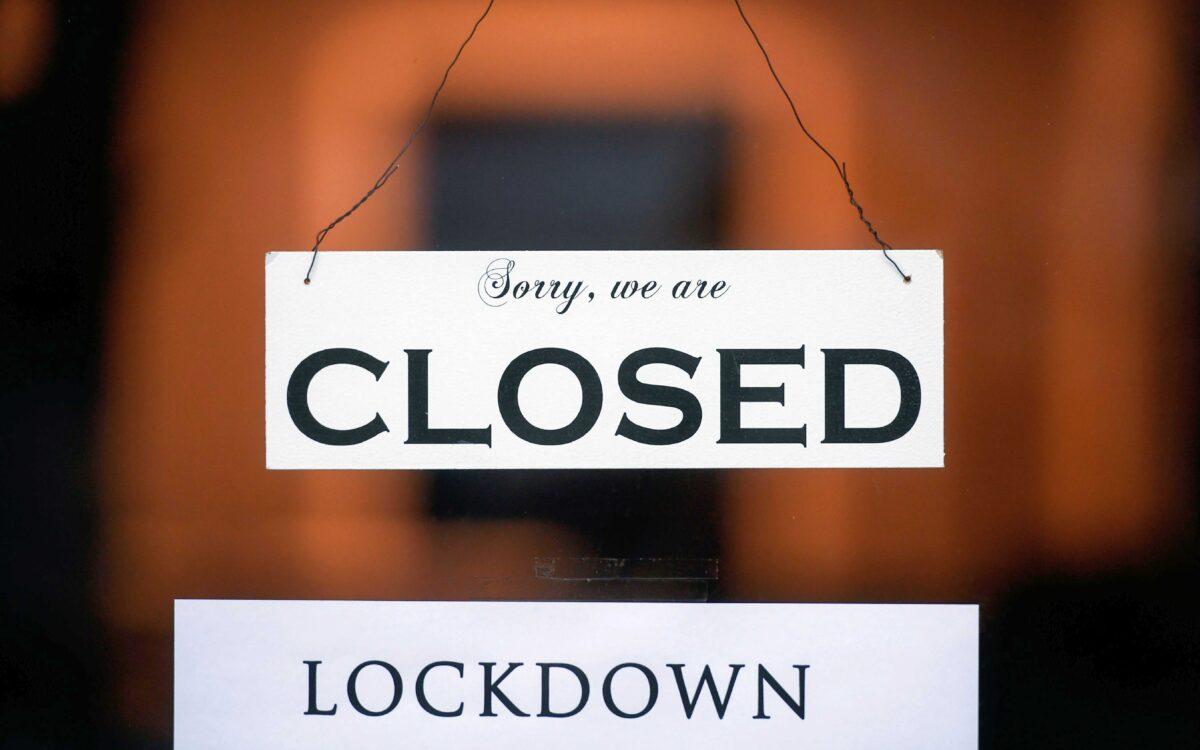A sign reading 'Sorry, we are closed' is seen at a shop in Cologne, western Germany, on Jan. 4, 2021. (Ina Fassbender/AFP via Getty Images)