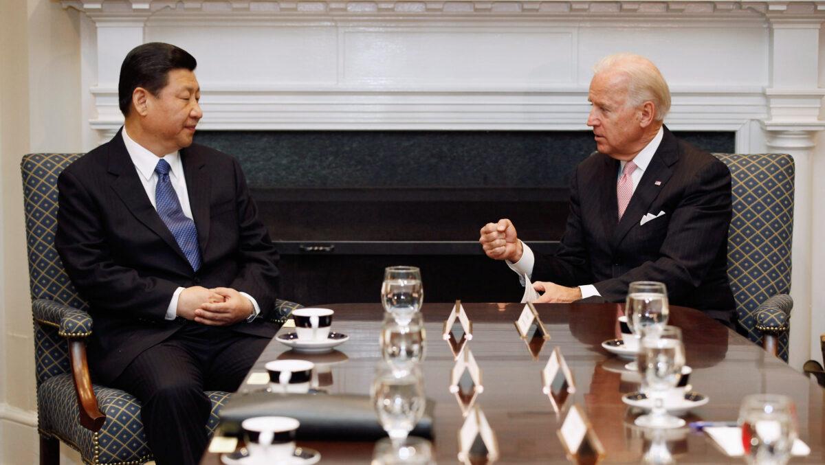 Then U.S. Vice President Joe Biden (R) and then Chinese Vice Chair Xi Jinping talk during an expanded bilateral meeting with other U.S. and Chinese officials in the Roosevelt Room at the White House in Washington on Feb. 14, 2012. (Chip Somodevilla/Getty Images)