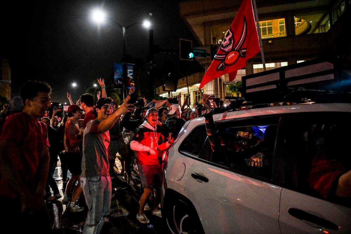 Tampa Bay Buccaneers fans celebrate their victory over the Kansas City Chiefs during Super Bowl LV in a street in downtown Tampa, Fla., on Feb. 7, 2021. (Chandan Khanna/AFP via Getty Images)
