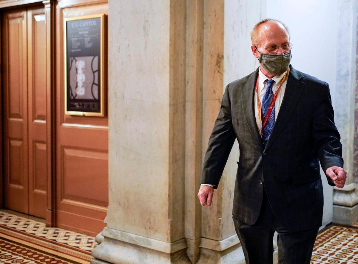 David Schoen, lawyer for former President Donald Trump, walks on Capitol Hill during a break in the second impeachment trial of Trump, at the Capitol in Washington on Feb. 10, 2021. (Joshua Roberts/Pool via AP)