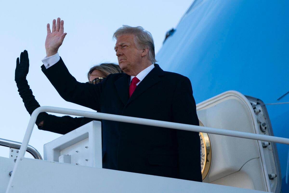 Then-President Donald Trump and First Lady Melania Trump step into Air Force One at Joint Base Andrews in Maryland on Jan. 20, 2021 (Alex Edelman/AFP via Getty Images)