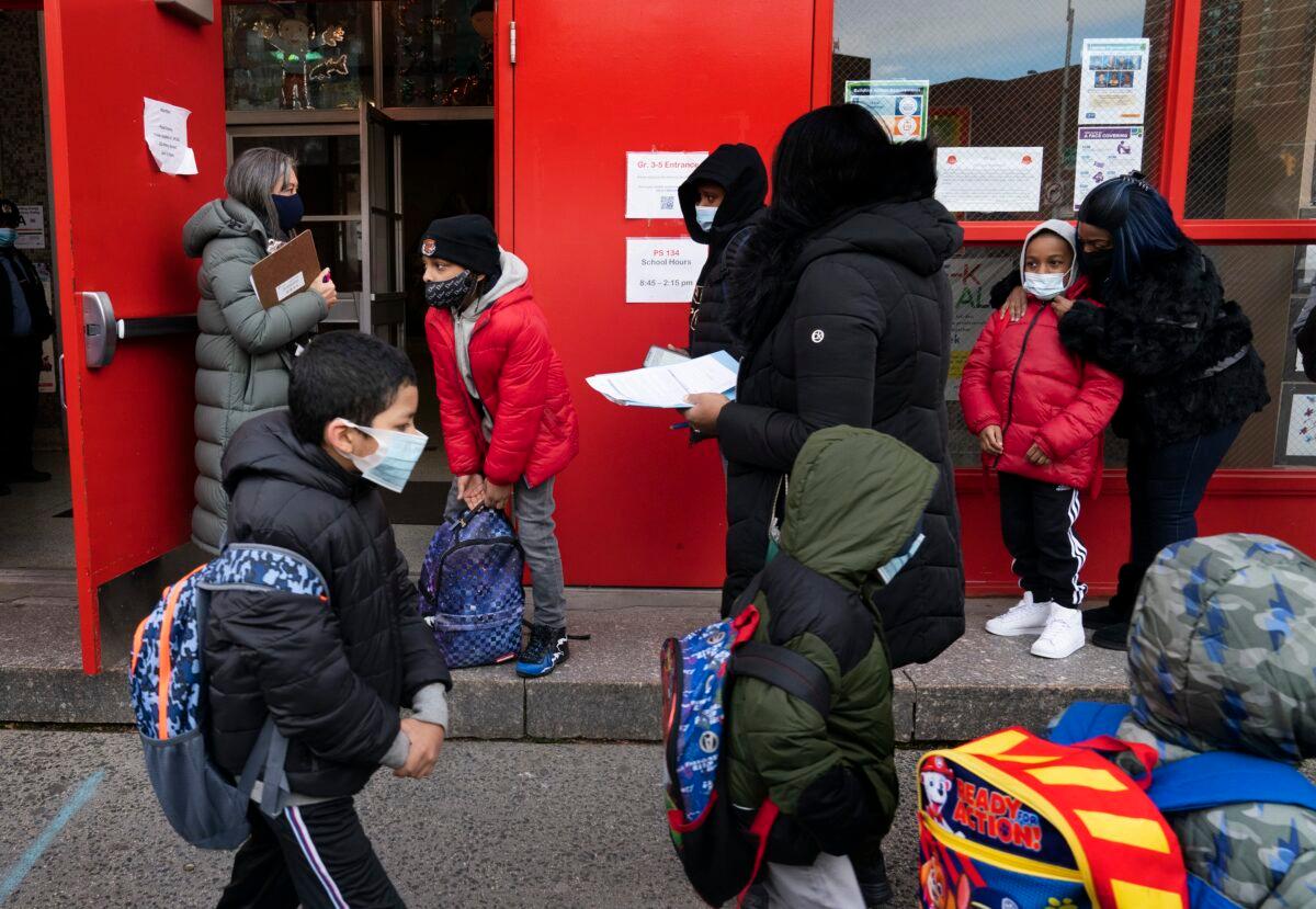 Students enter P.S. 134 Henrietta Szold Elementary School in New York on Dec. 7, 2020. (Mark Lennihan/AP Photo)