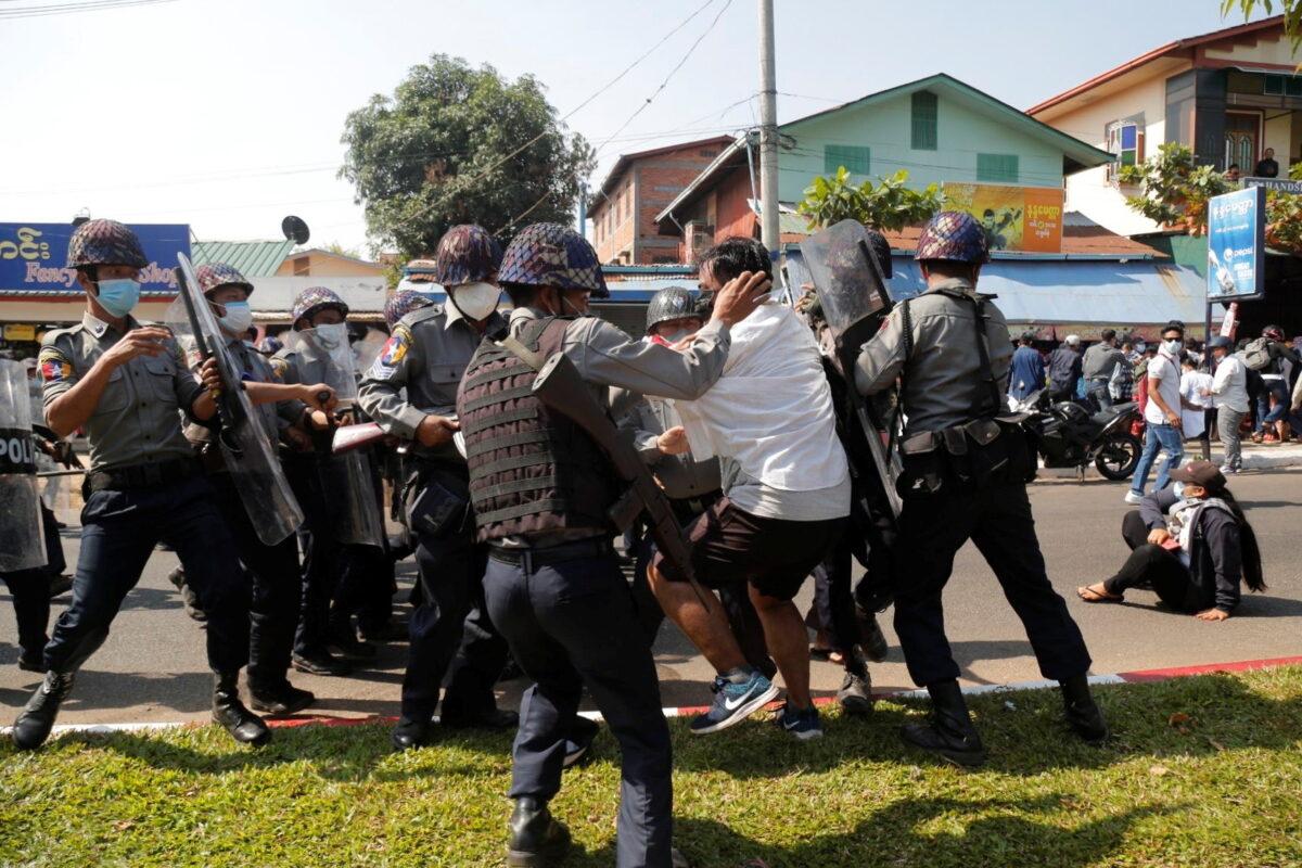 A demonstrator is detained by police officers during a protest against the military coup in Mawlamyine, Burma, on Feb. 12, 2021. (Than Lwin Times/Handout via Reuters)
