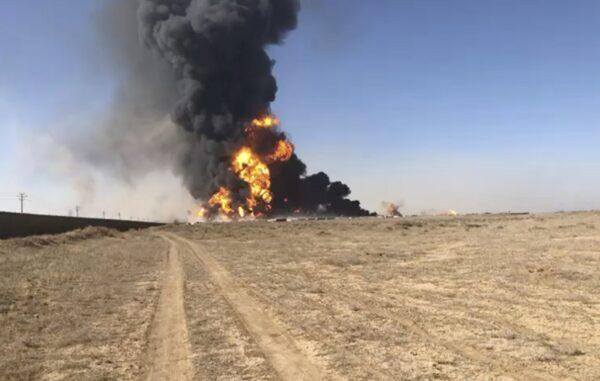 In this still image taken from video, smoke rises from fuel tankers at the Islam Qala border with Iran, in Herat Province, west of Kabul, Afghanistan on Feb. 13, 2021. (AP Photo)