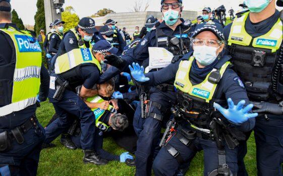 Police tackle protesters in Melbourne on Sept. 5, 2020 during an anti-lockdown rally protesting the state's strict lockdown laws as a preventive measure against the COVID-19 coronavirus. (William West/AFP via Getty Images)