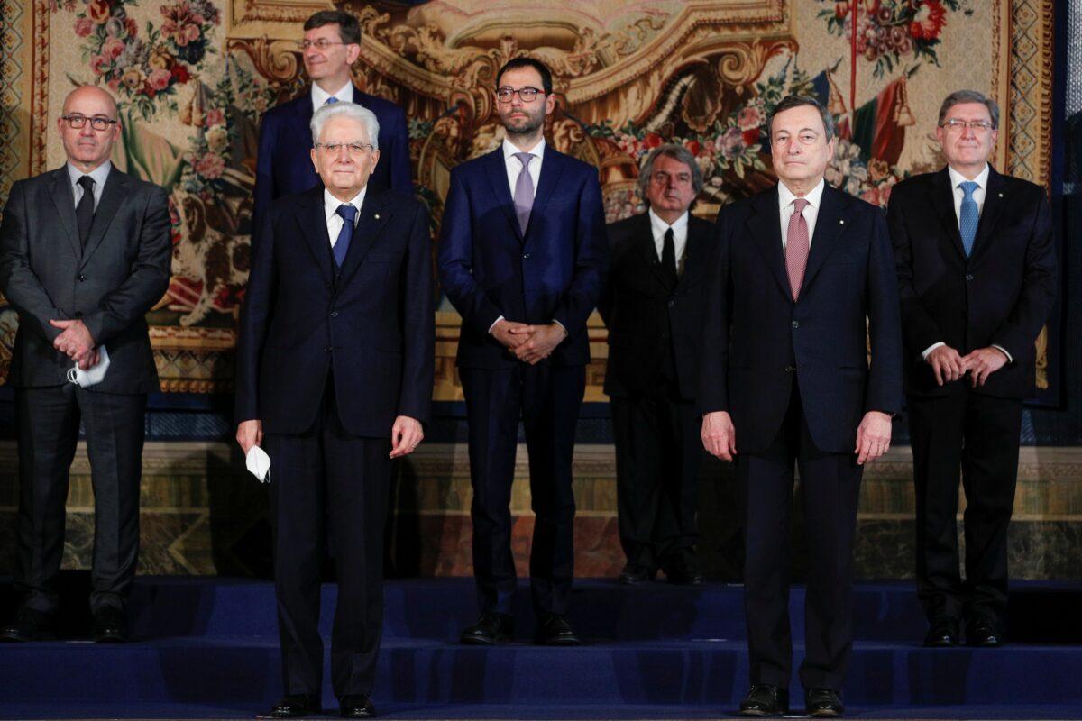Italian President Sergio Mattarella and Prime Minister Mario Draghi stand with the government's new cabinet ministers after their swearing-in ceremony, at the Quirinale Presidential Palace in Rome, Italy, Feb. 13, 2021. (Guglielmo Mangiapane/Reuters, Pool)