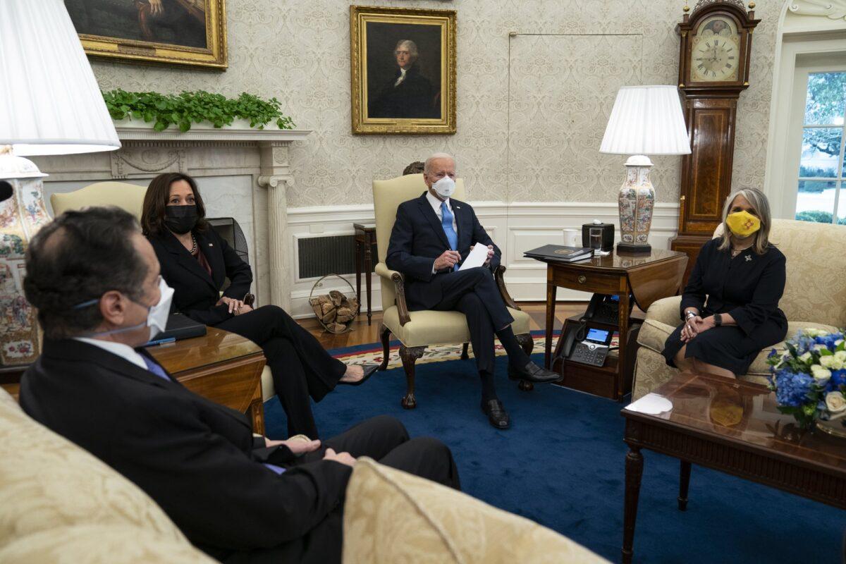 President Joe Biden speaks during a meeting with a bipartisan group of mayors and governors to discuss a COVID-19 relief package, in the Oval Office of the White House in Washington, on Feb. 12, 2021. From left, Gov. Andrew Cuomo (D-N.Y.), Vice President Kamala Harris, Biden, and Gov. Michelle Lujan Grisham (D-N.M.). (Evan Vucci/AP Photo)