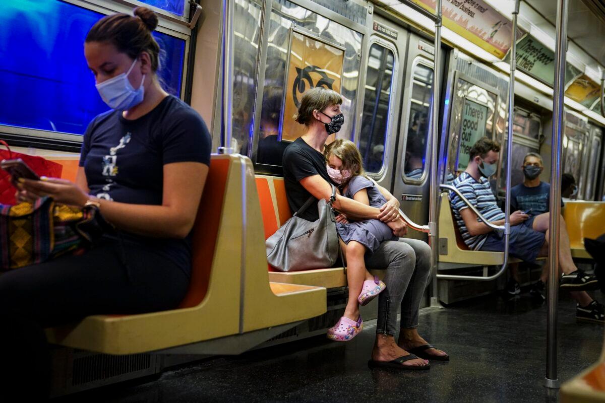 Riders on a subway train wear protective masks due to COVID-19 concerns in New York on Aug. 17, 2020. (John Minchillo/AP Photo)