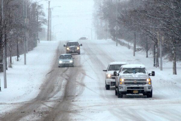 Traffic makes its way down a snow-covered stretch of East Front Street near downtown Port Angeles, Wash., on Feb. 13, 2021. (Keith Thorpe/Peninsula Daily News/AP)