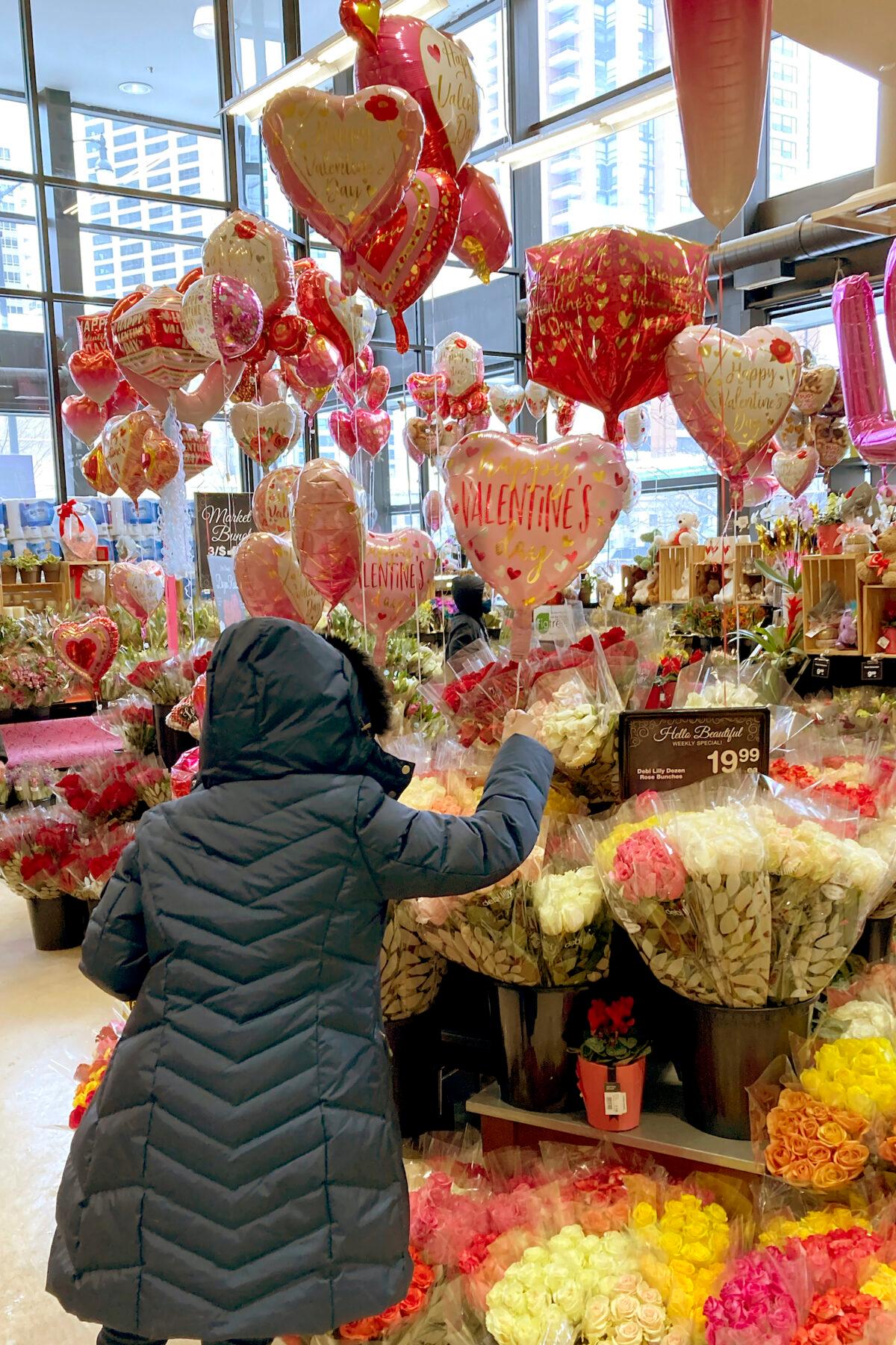 A shopper looks over Valentine's Day gifts at a Chicago area grocery store on Feb. 13, 2021. (Charles Rex Arbogast/AP)