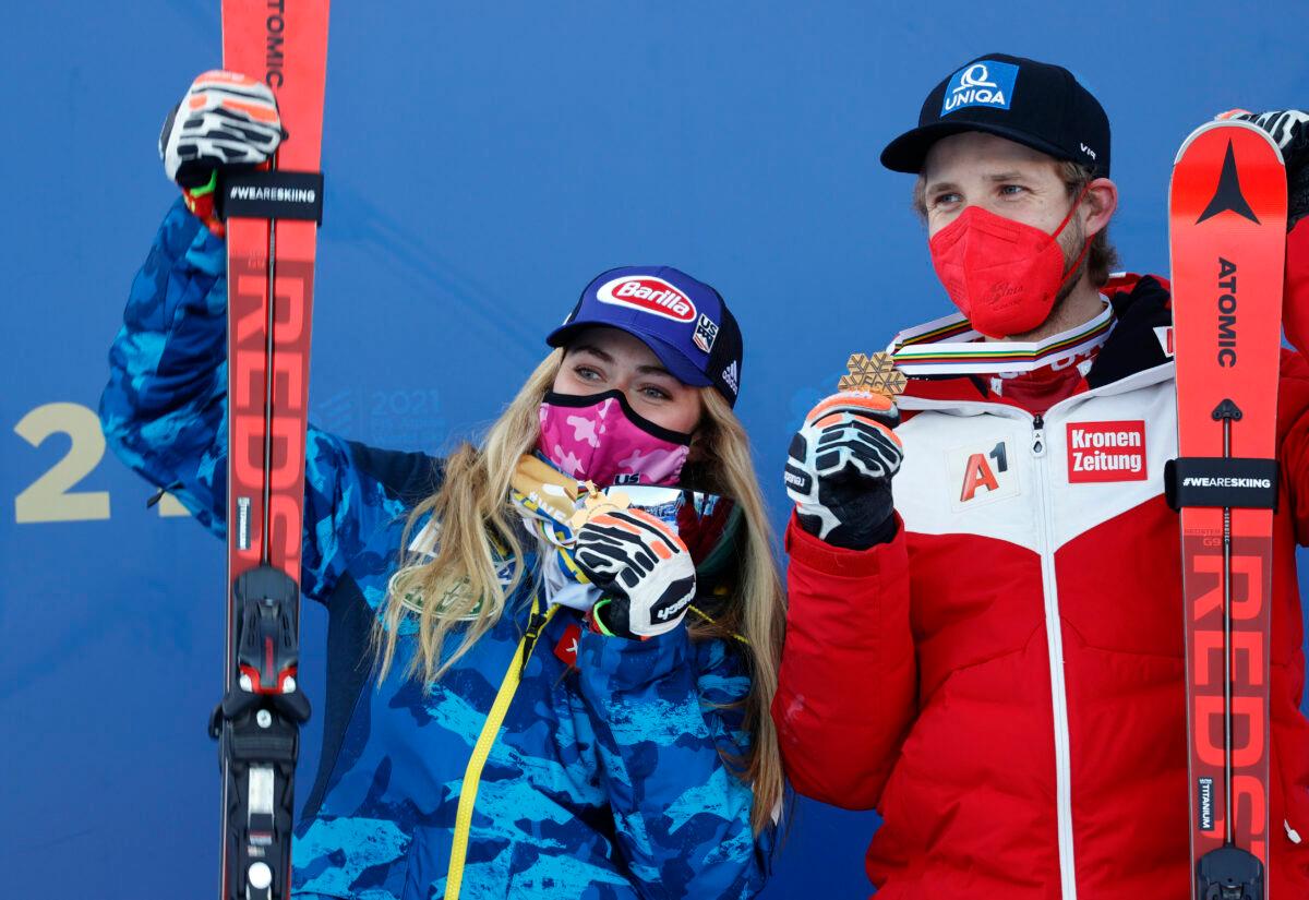 Gold medalist in the women’s Alpine Combined Mikaela Shiffrin of the U.S. and gold medalist in the men’s Alpine Combined Marco Schwarz of Austria pose for a photo with their medals in Cortina d'Ampezzo, Italy, on Feb.15, 2021. (Leonhard Foeger/Reuters)