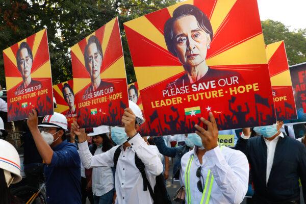 Engineers hold posters with an image of deposed Myanmar leader Aung San Suu Kyi as they hold an anti-coup protest march in Mandalay, Burma, on Feb. 15, 2021.  (AP Photo)