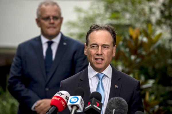 Health Minister Greg Hunt speaks as Prime Minister Scott Morrison looks on at the news conference at the CSL facility on February 12, 2021, in Melbourne, Australia. (Diego Fedele/Getty Images)