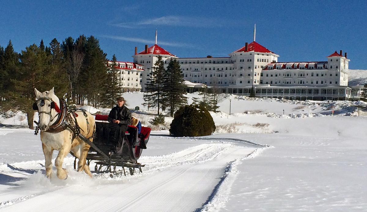 A winter sleigh ride set against the background of the Omni Mount Washington Resort. (Courtesy of Omni Mount Washington Resort)