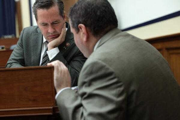 Rep. Michael Waltz (R-Fla.) listens to an aide during a hearing before the House Armed Services Committee on Capitol Hill in Washington on Dec. 11, 2019. (Alex Wong/Getty Images)