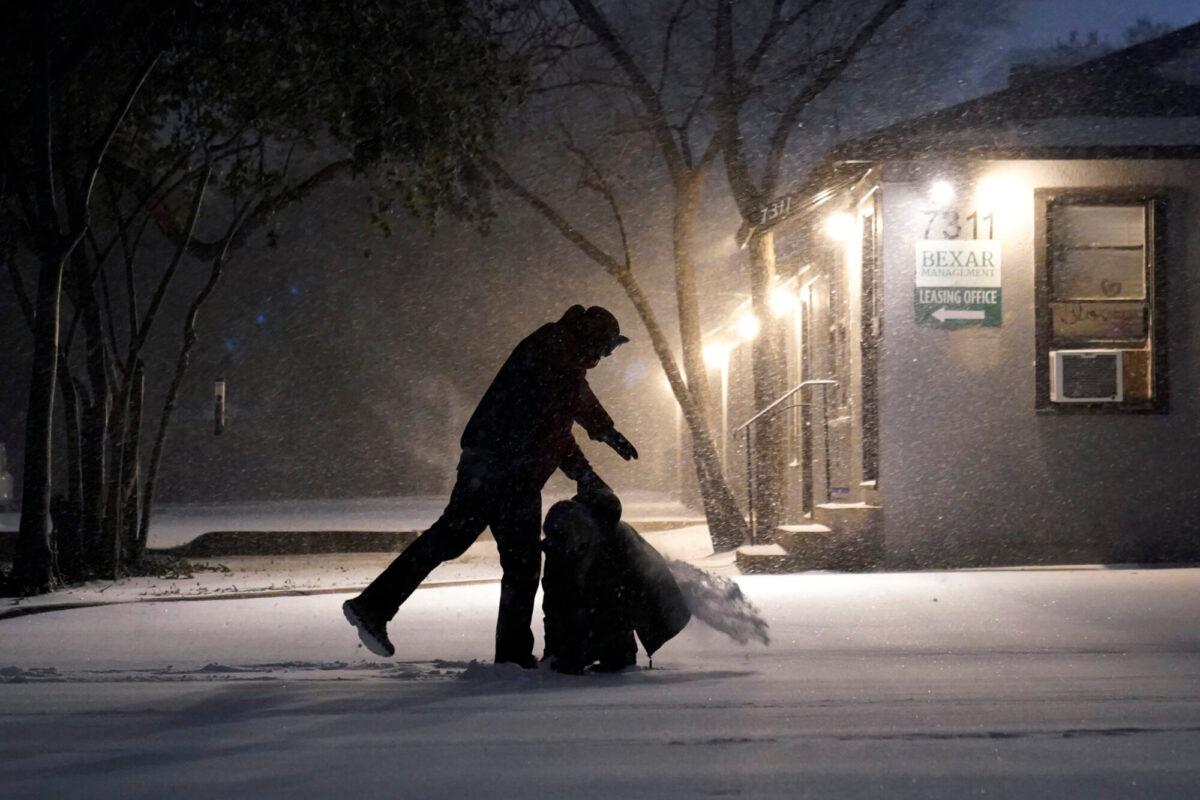 Two people play in the snow in San Antonio, Texas, on Feb. 14, 2021. (Eric Gay/AP Photo)