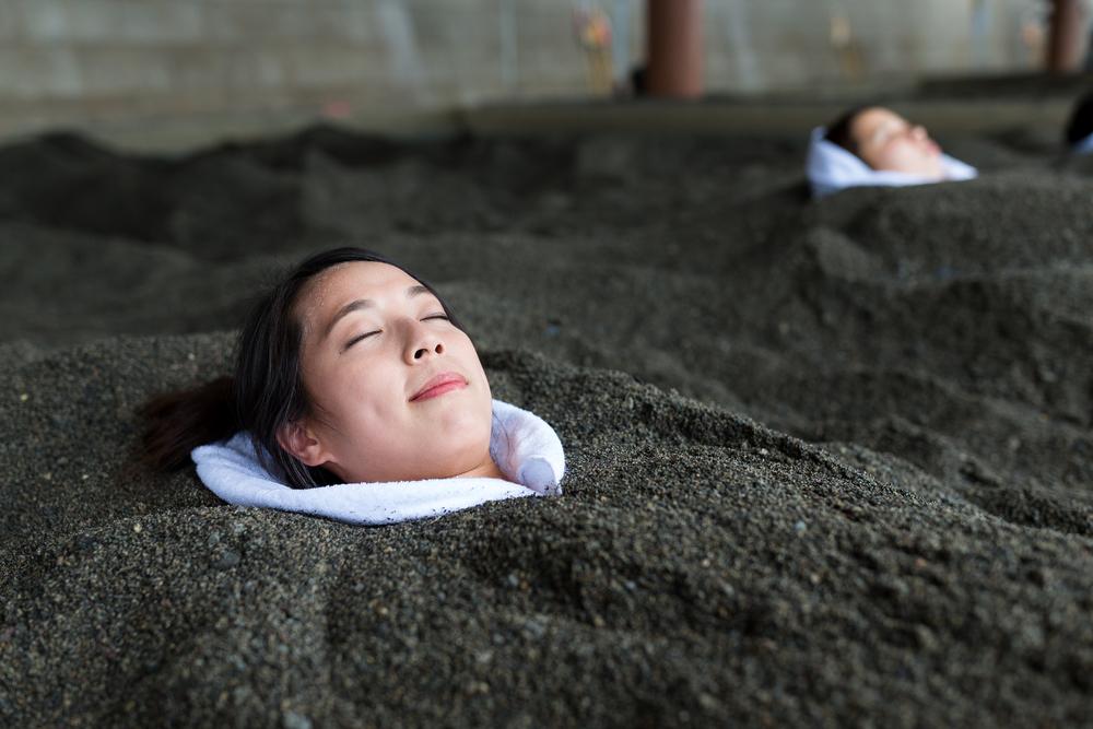 In Beppu, Japan, try a hot sand bath. (leungchopan/Shutterstock)