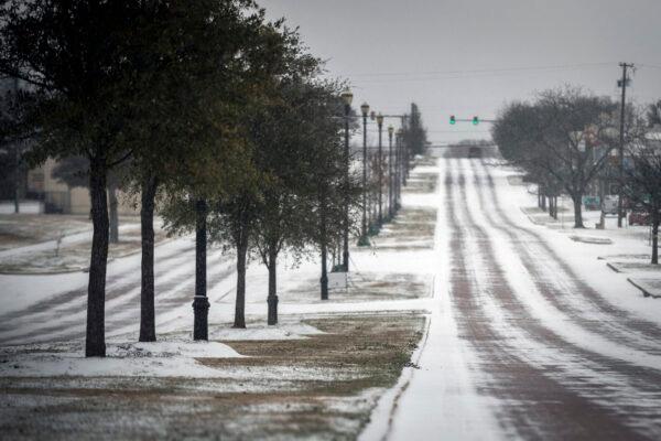 Snow is shown along Camp Bowie Blvd. in Fort Worth, Texas, on Feb. 14, 2021. (Yffy Yassifor/Star-Telegram via AP)