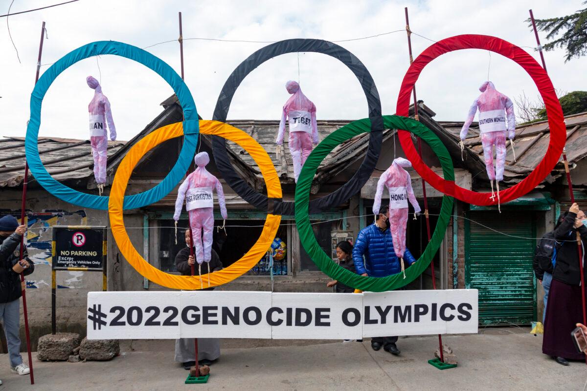 Exiled Tibetans use the Olympic Rings as a prop during a street protest against the holding of the 2022 Winter Olympics in Beijing, in Dharmsala, India, on Feb. 3, 2021. (Ashwini Bhatia/AP Photo)