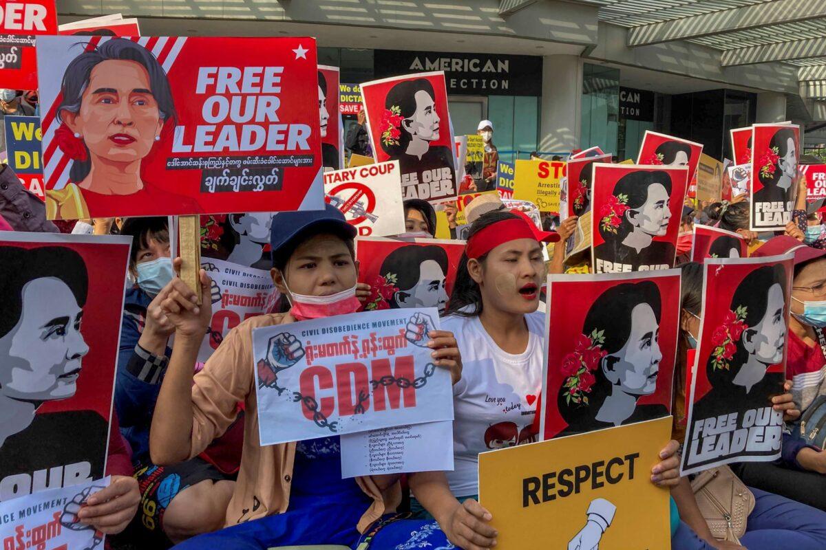Demonstrators display images of detained Burma leader Aung San Suu Kyi during a protest against the military coup in Yangon, Burma, on Feb. 16, 2021. (AP Photo)