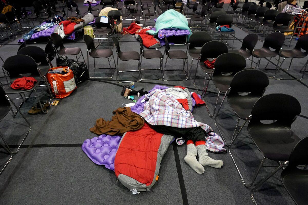 People seeking shelter from below freezing temperatures rest inside a church warming center in Houston on Feb. 16, 2021. (David J. Phillip/AP Photo)
