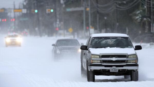 Vehicles drive on snow and sleet covered roads in Spring, Texas, on Feb. 15, 2021. (David J. Phillip/AP Photo)